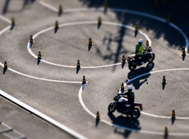 a group of people riding motorcycles around a circle